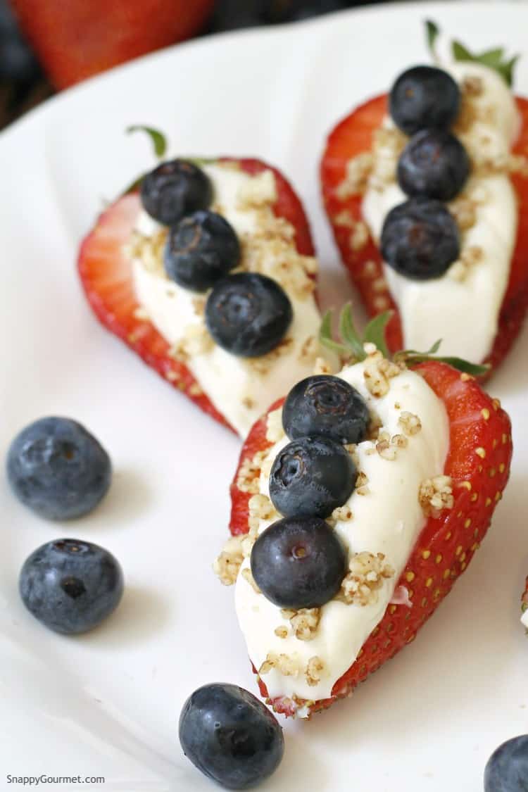 Strawberries stuffed with filling and topped with blueberries