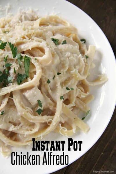homemade Instant Pot Chicken Alfredo on white plate with parsley