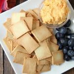Almond Flour Crackers on white plate with cheese and berries