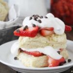 cannoli cream, shortcake, and strawberries stacked on plate