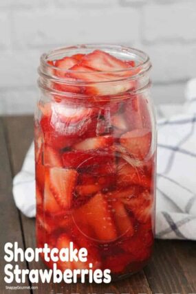 sliced strawberries in glass mason jar