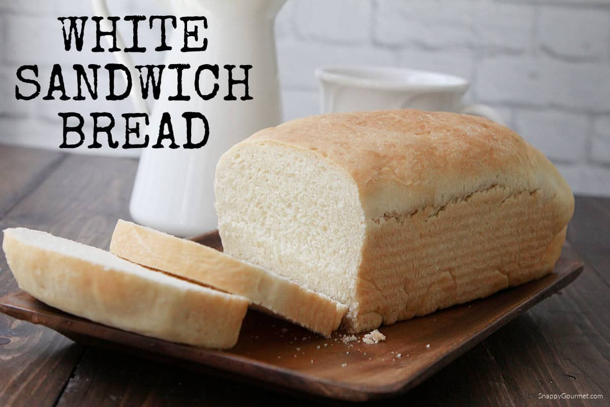 loaf of white sandwich bread on wood tray