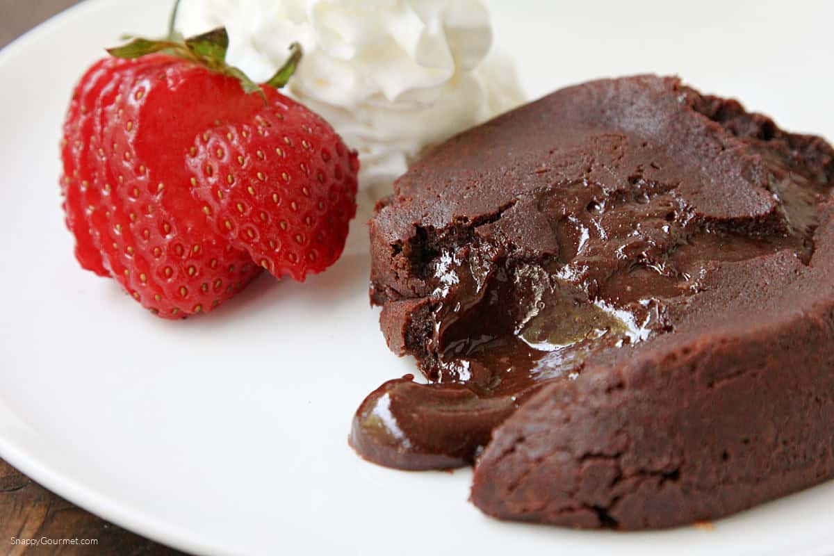 Chocolate Molten Lava Cake on plate with strawberry and whipped cream