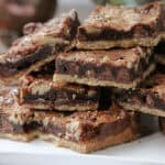 stacked of Chocolate Pecan Pie Bars on plate