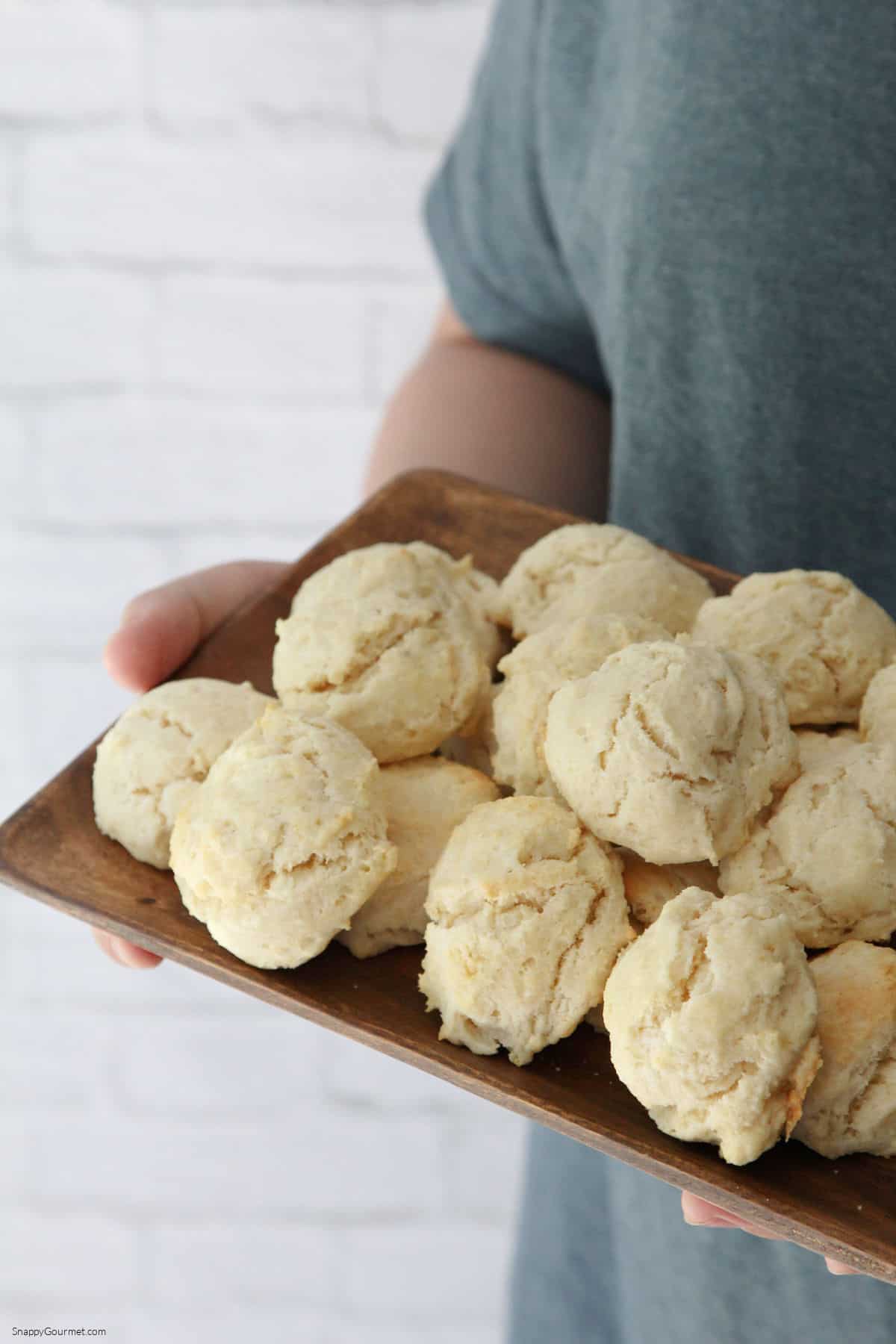 Drop Biscuits someone holding wood platter with drop biscuits