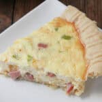 slice of homemade Ham and Cheese Quiche on plate