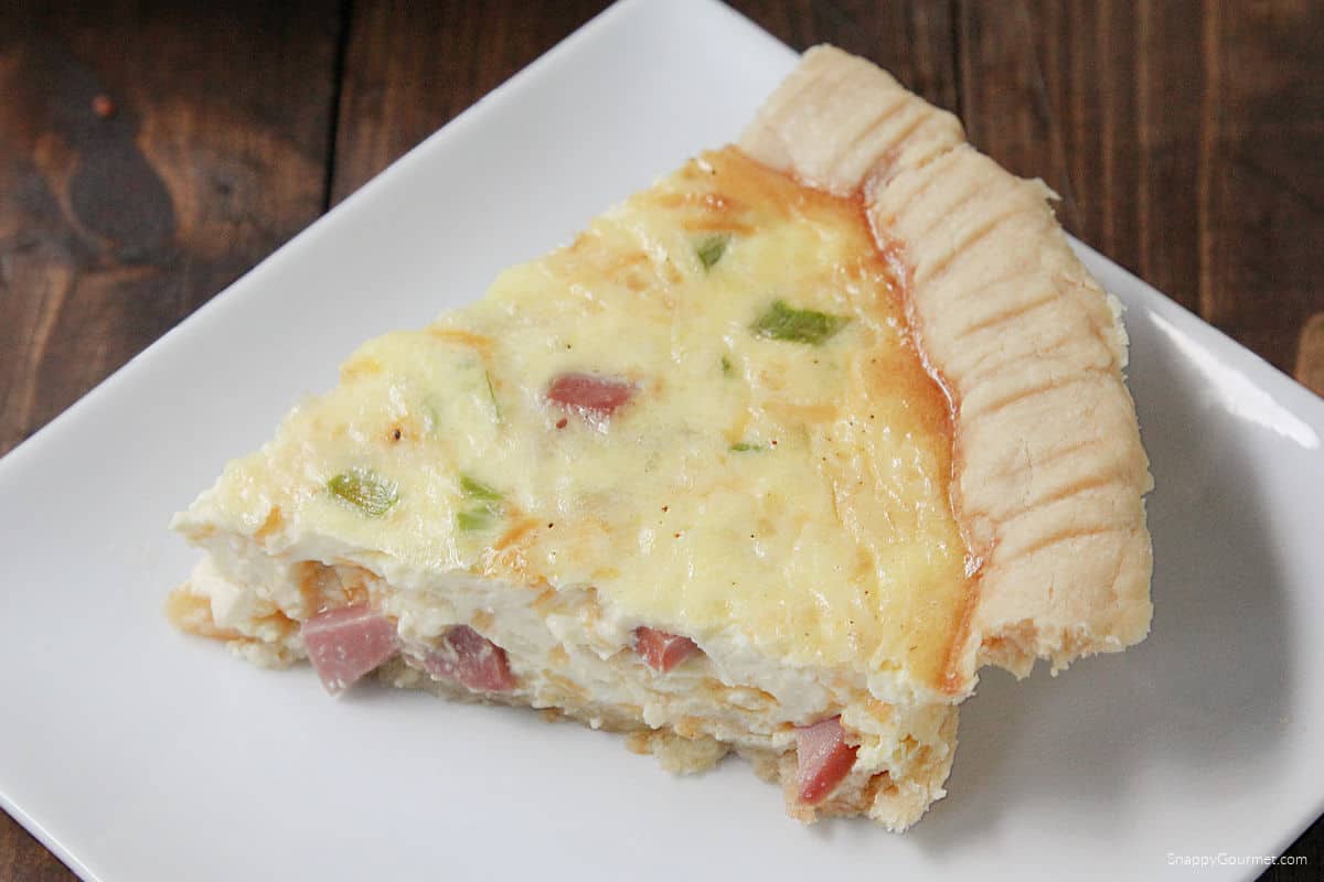 Ham and Cheese Quiche slice of homemade Ham and Cheese Quiche on plate