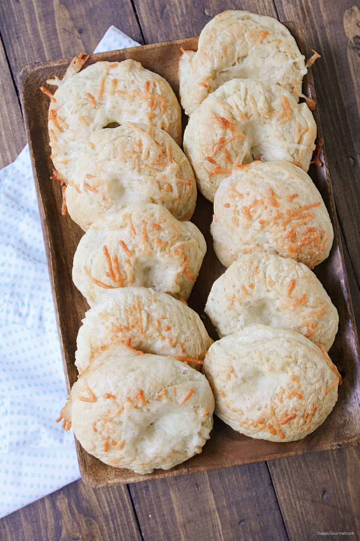 assortment of Mini Asiago Bagels on wood platter