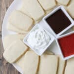 homemade Shortbread Cookie Sticks on plate with three dipping sauces in small bowls
