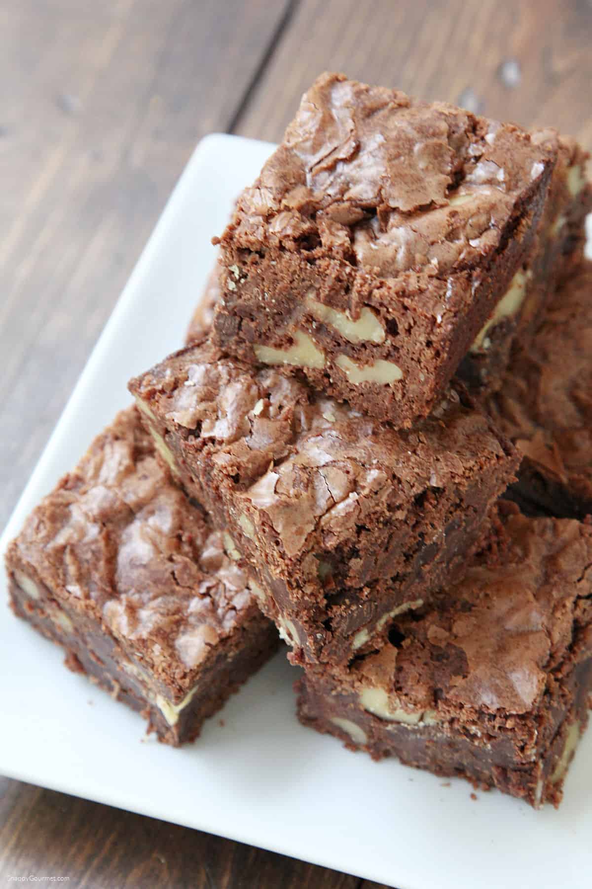 Walnut Brownies stacked on plate