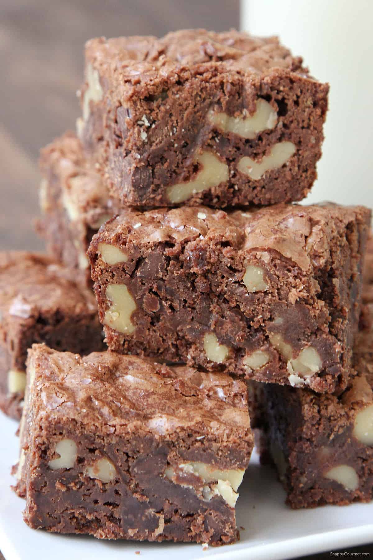 Walnut Brownies stacked on plate